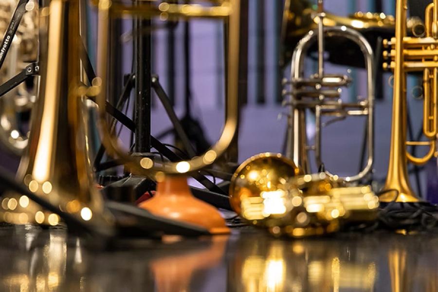 A collection of brass instruments on a stage.