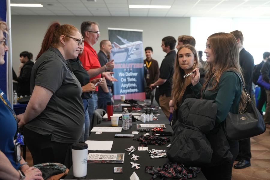 Students talking to employers at career fair