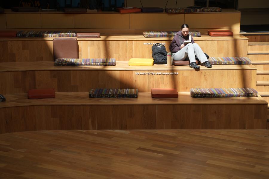 A student studies on the gathering stairs