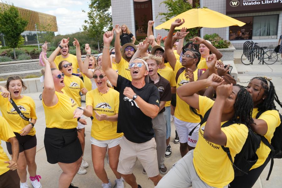 A group of students cheers.