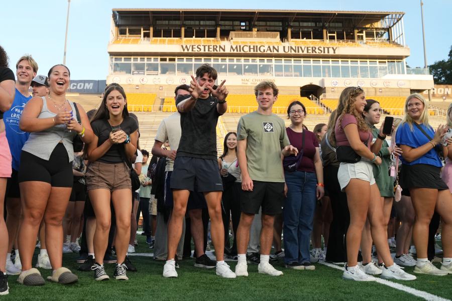 Students throw up the W.