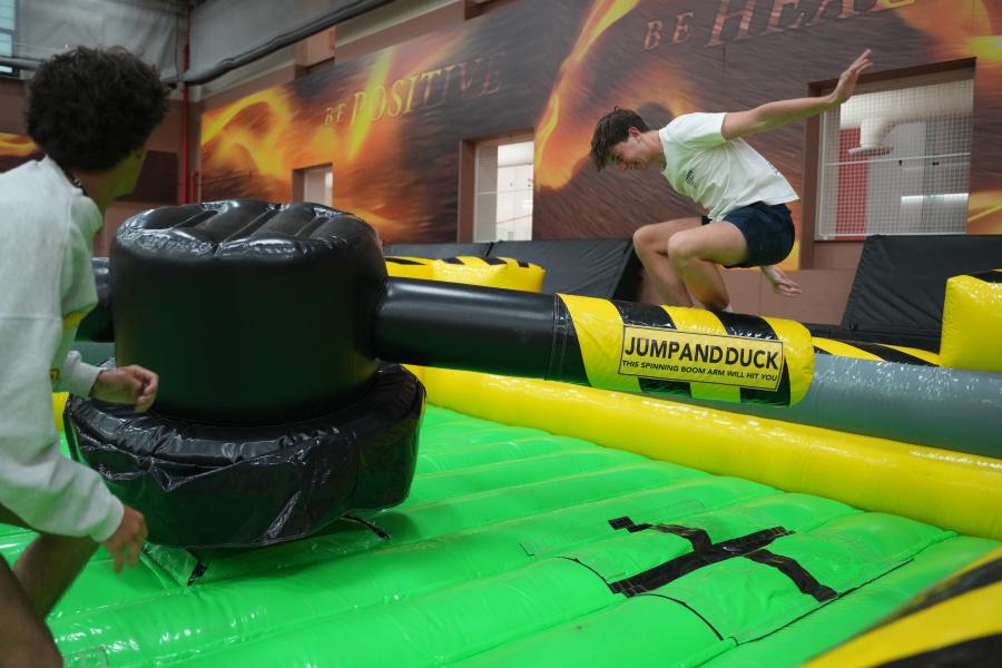 Students play on an inflatable feature.