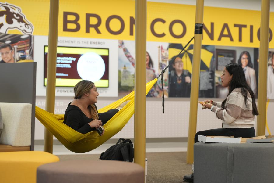 Students hang out in hammocks in the student center