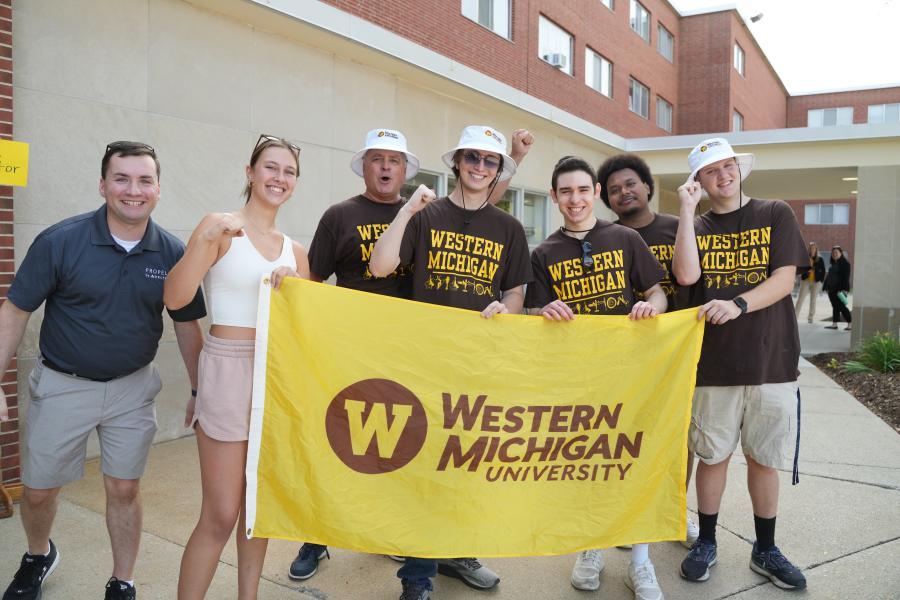 Students holding a WMU flag during move in 2024