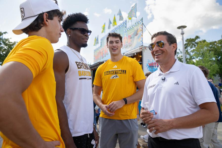 President Russ Kavalhuna talks with people.