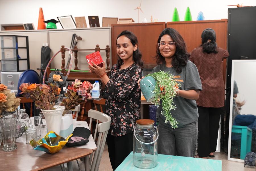 Students pose with plants.
