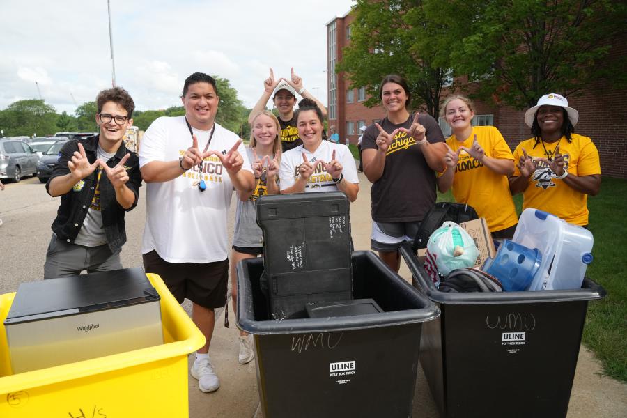 Move-in volunteers from the College of Aviation stand by move-in carts.