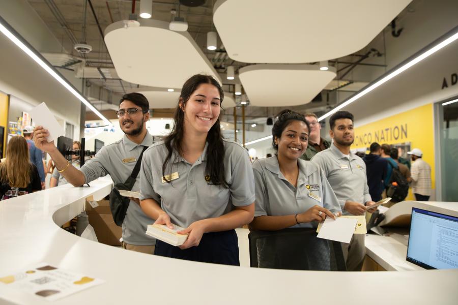 Students working at the info desk