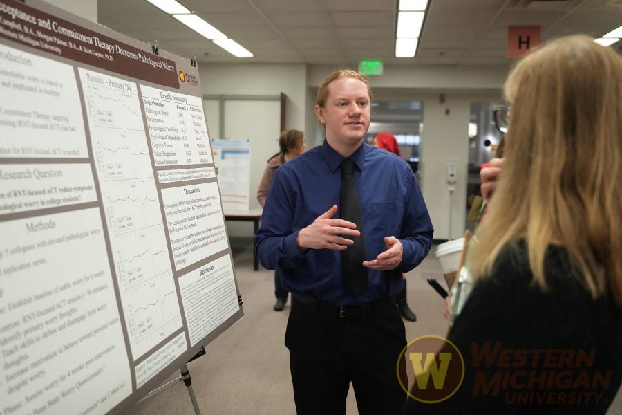 Grad student presenting research poster