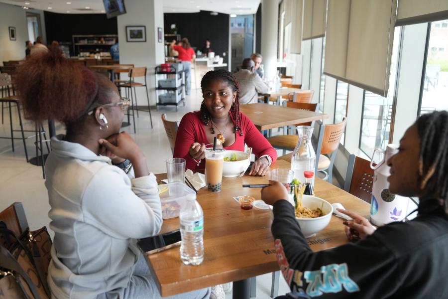 Students eat food in HOU JIA Kitchen and Bar.