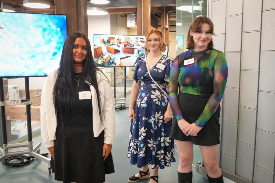 Avery McNew, Sofia Huffman and Mackenzie Willey stand in their ArtPrize gallery.