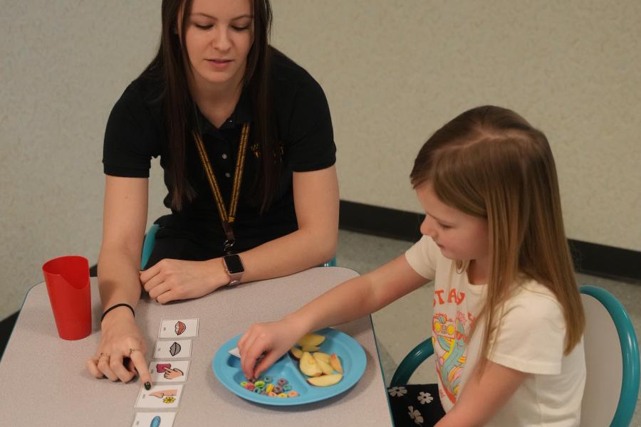 clinician feeding a child