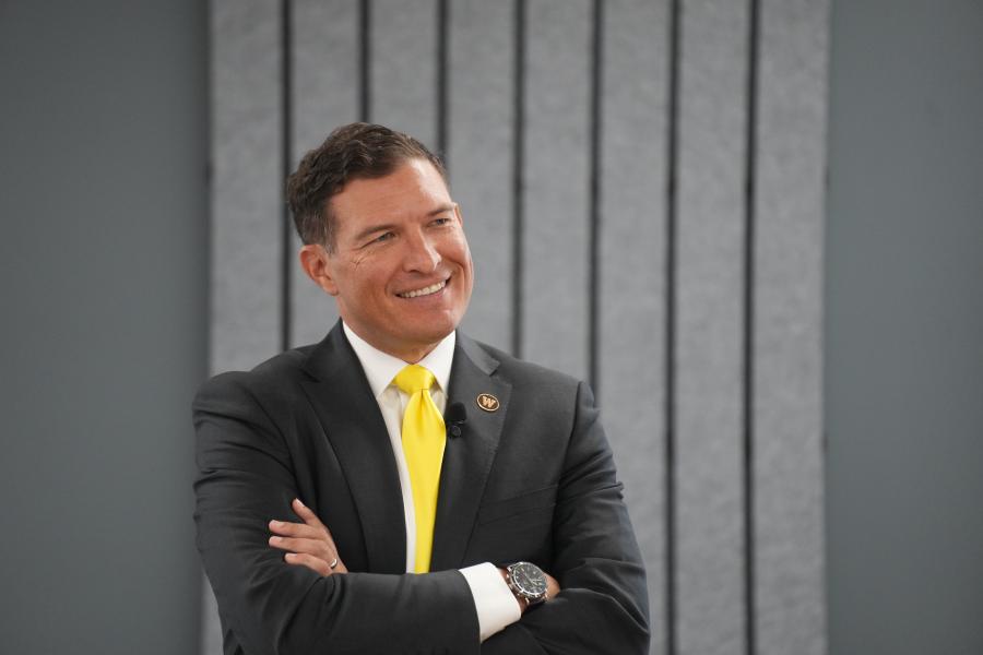 President Russ Kavalhuna smiles with his arms crossed over his chest.
