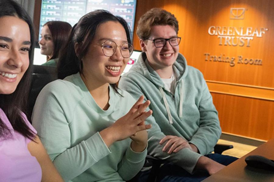 Students at a table smiling