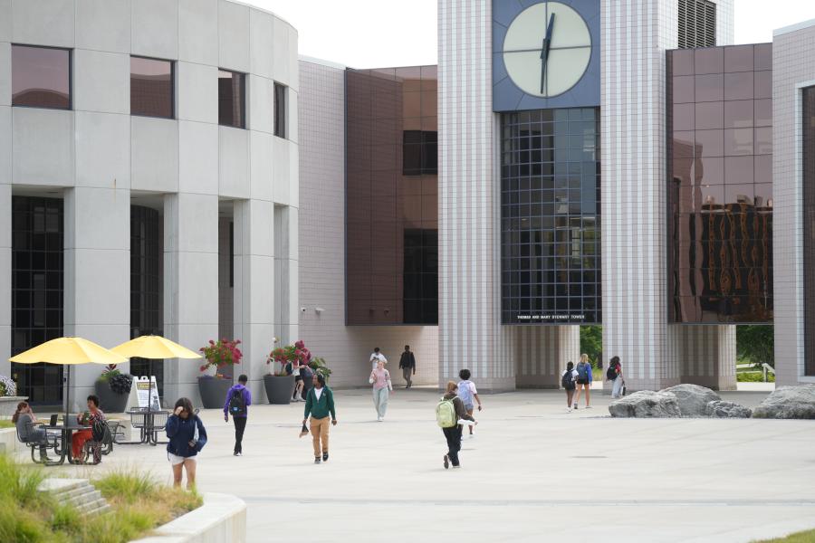 Student walking in front of Waldo Library.