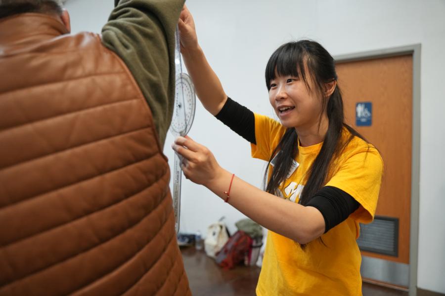 A student measure range of motion on a patient.