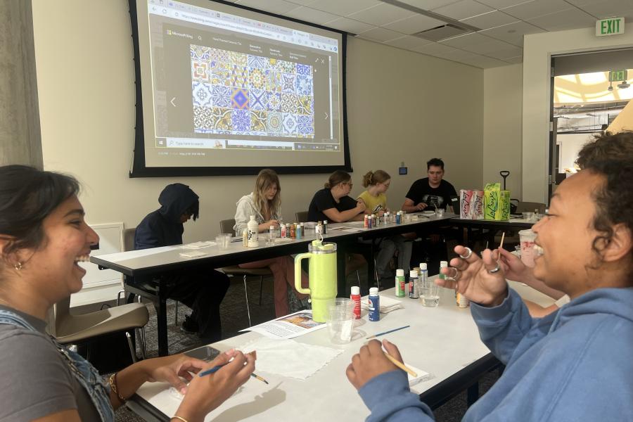A photo of students painting tiles