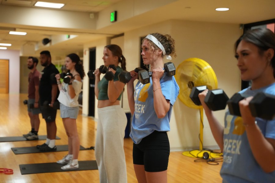 Students working out with weights in the aerobics studio at the SRC.