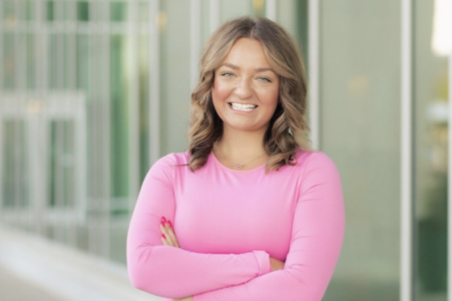Madison Sedmak wearing a pink shirt and standing outside