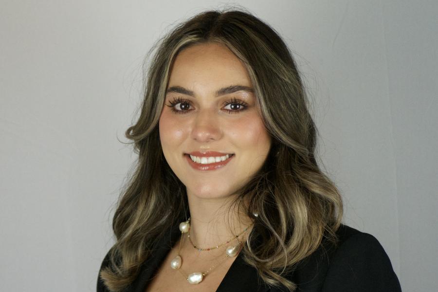 Headshot of Daniela Padilla in a white top and black blazer on a white background