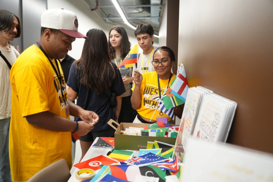 Students sort through flags from around the world at International Student Orientation.