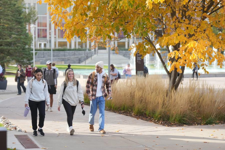 Student walking on campus during the fall