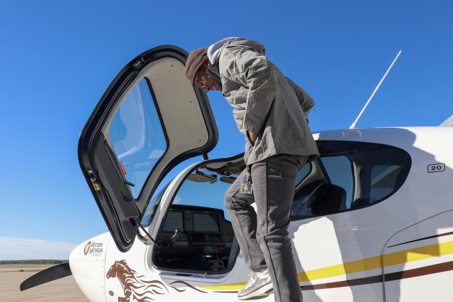 person stepping in plane