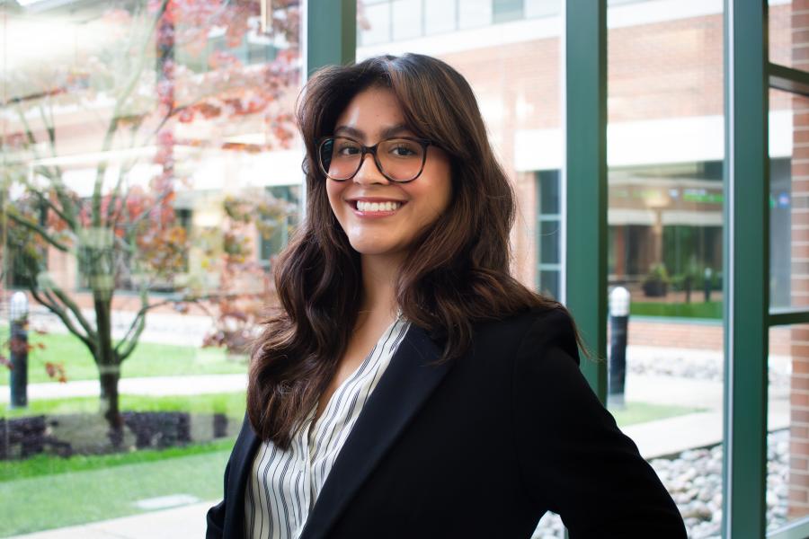 Karen Xospa smiling and standing in the hallway