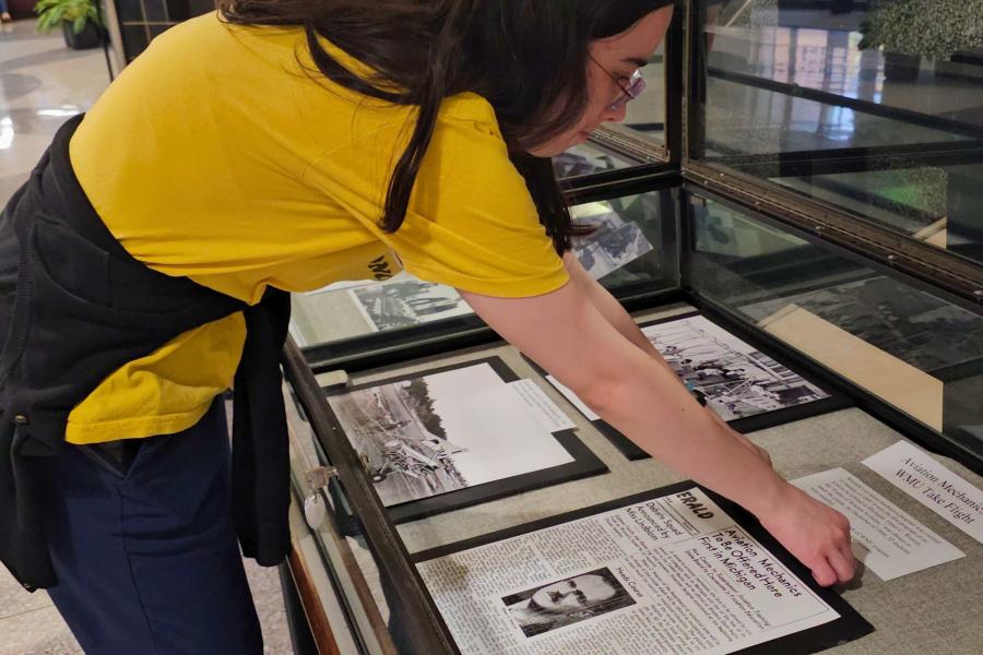 Western Michigan University student Meena Jacobs working on exhibit case about aviation mechanics at WMU.