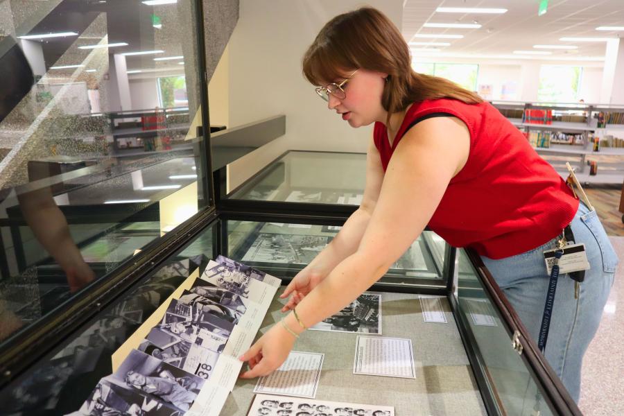 Western Michigan University student Malia Garrison working on exhibit case about women in aviation.