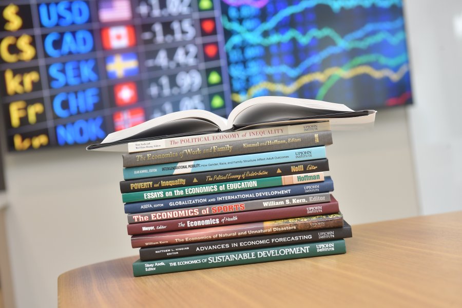 Stack of Economics Textbooks 