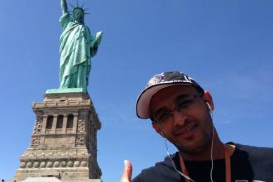 Ali posing with the Statue of Liberty