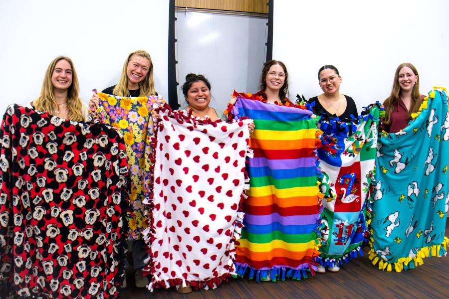 education students holding blankets