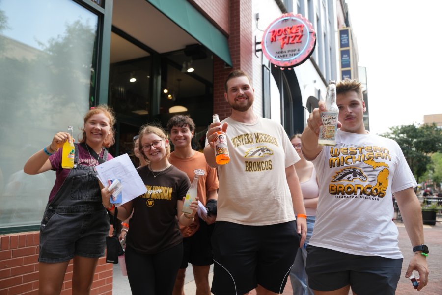 Students drink soda in front of Rocket Fizz downtown.
