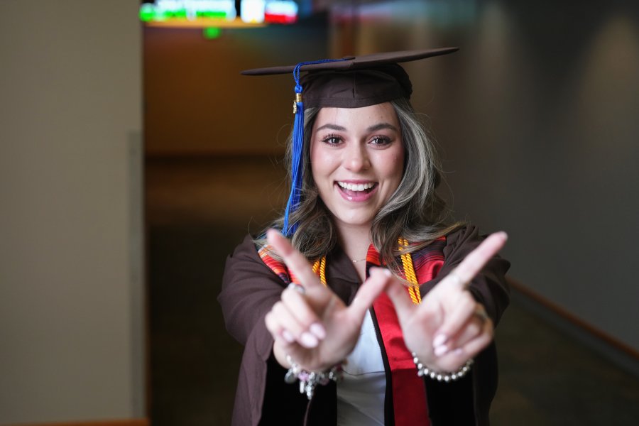 Daniela Padilla holds her hands up in a W shape.