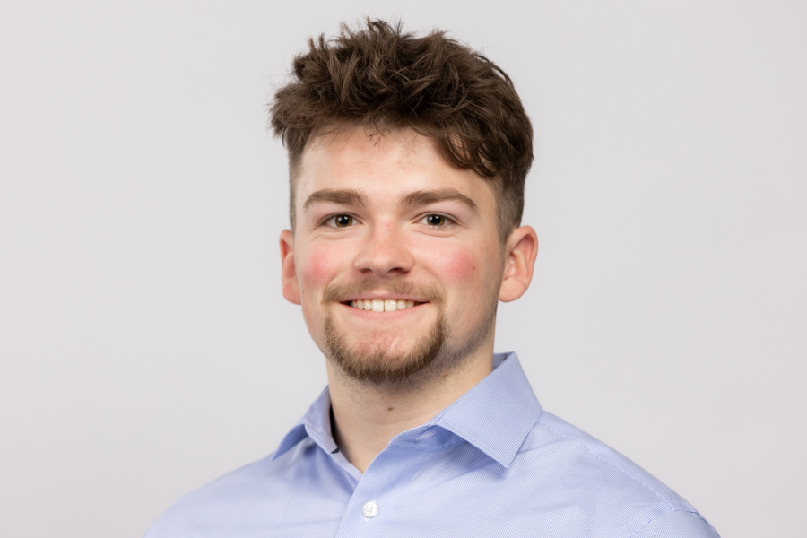 Nathan Clarke wearing a blue shirt against a light background