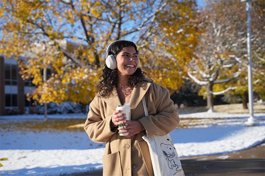 Student walking on campus in the snow