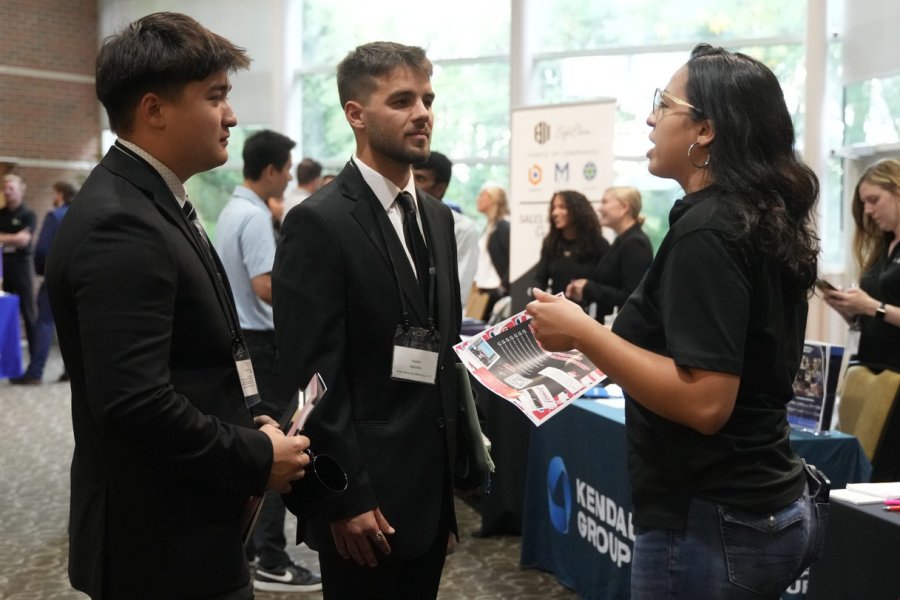Students talking to employers at job fair