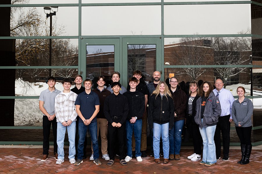A group of high school students standing in front of the College of Business