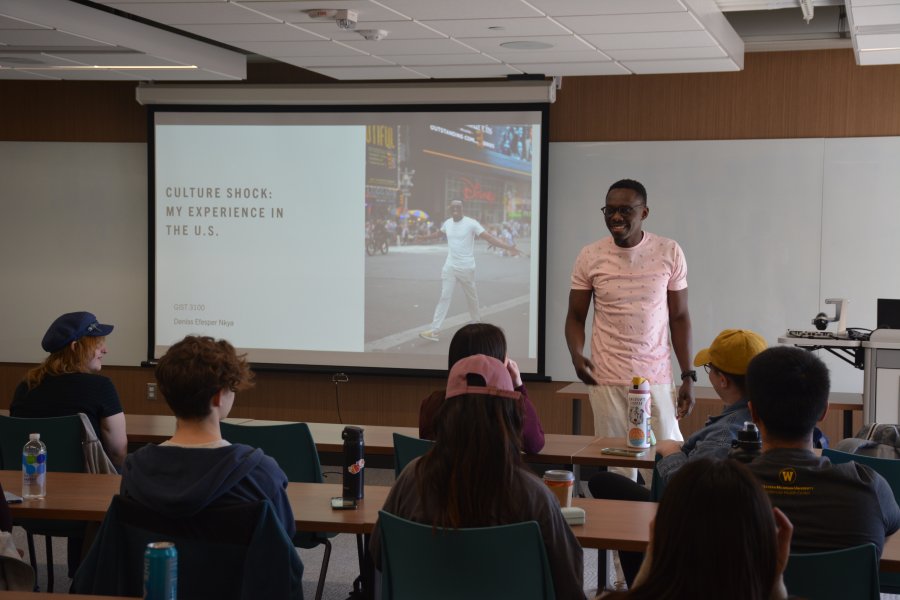 An image of a student presenting to a class about his experience with culture shock when he moved to the United States