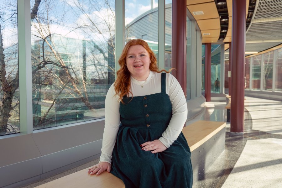 Cybersecurity student Erika Ekblaw sitting in Floyd Hall.