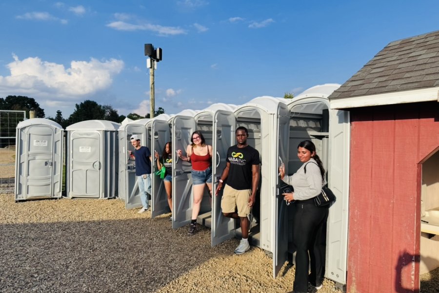 International student from India, Trivedi, stands for photo with WMU students.  