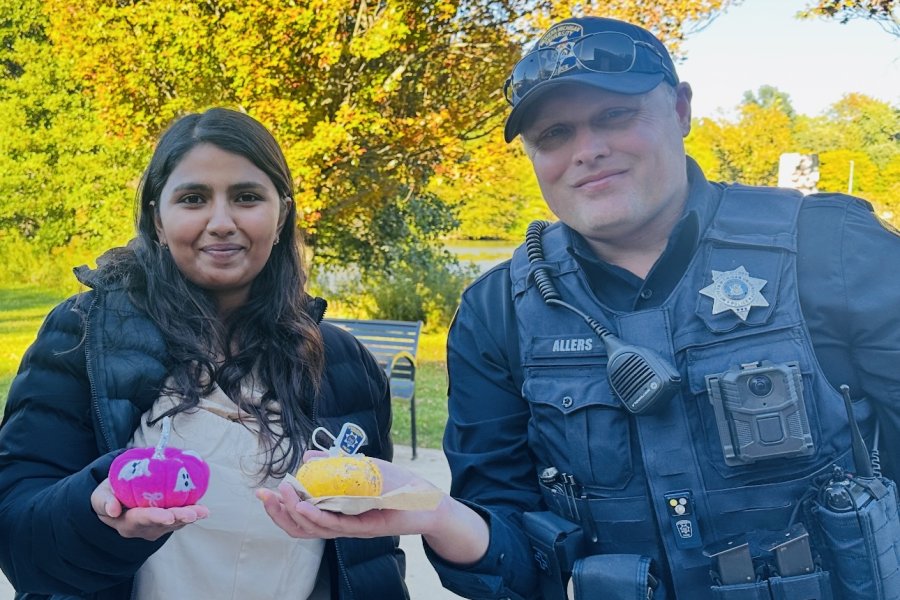 International student from India, Trivedi, stands for photo with WMU police officer.