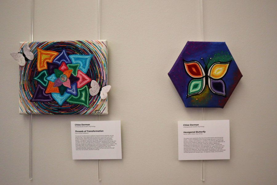 Two mixed media art pieces featured in the student exhibit at Waldo Library during spring 2026 semester.