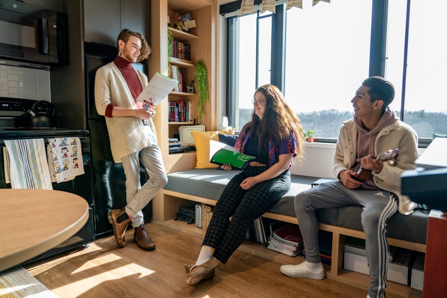 Three students hang out in an Arcadia Flats apartment kitchen.