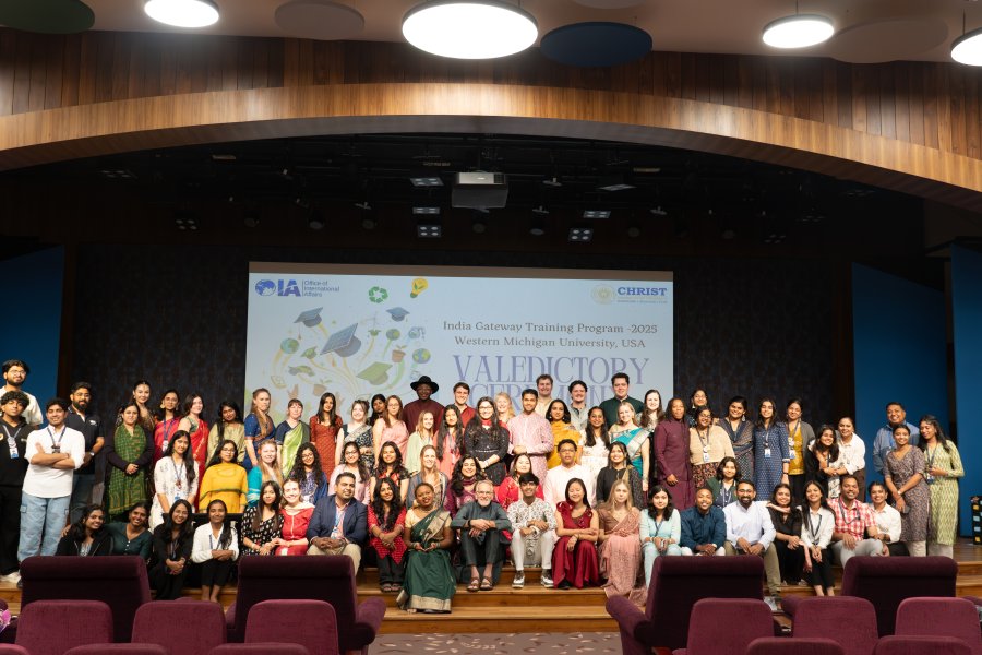 WMU students with Christ University students on a stage in celebration