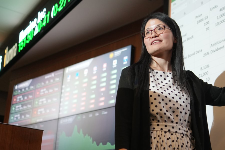 HCOB faculty in front of presentation