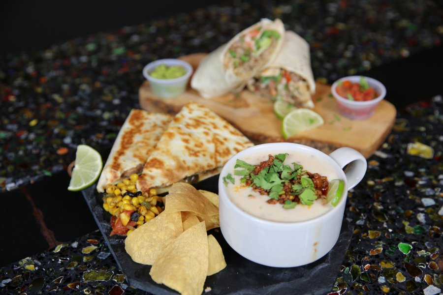 Food options from Fuego Verde displayed on a dark countertop.