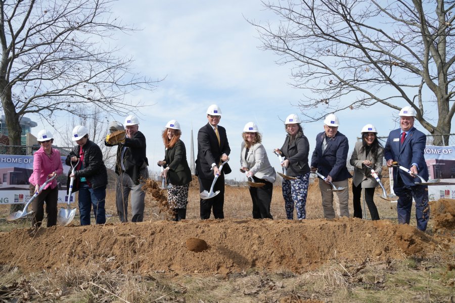 A group of WMU stakeholders tosses dirt into the air during the groundbreaking for the new Michigan Geological Repository for Research and Education on the WMU Parkview Campus.