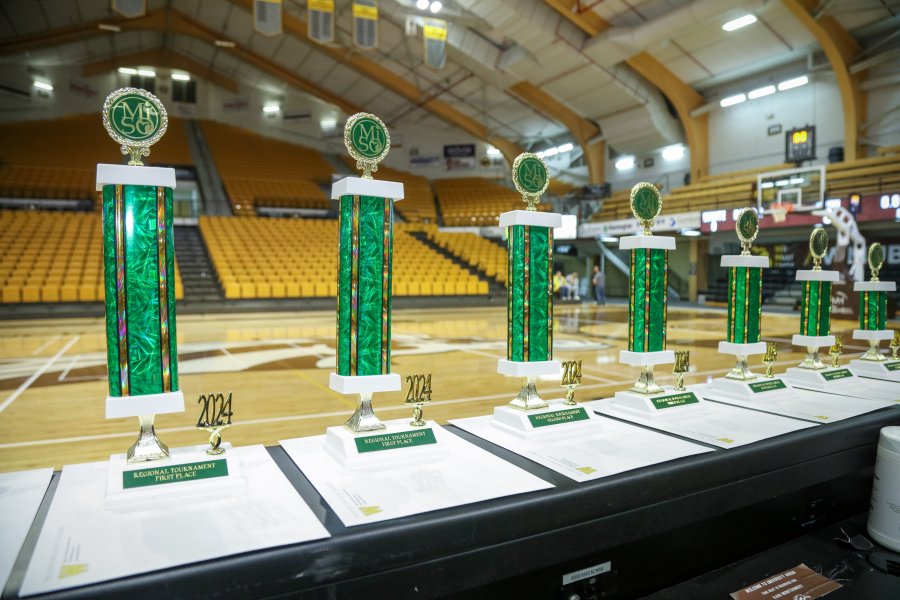 Trophies from the 2024 regional Science Olympiad tournament, hosted at WMU, lined up on a table. 